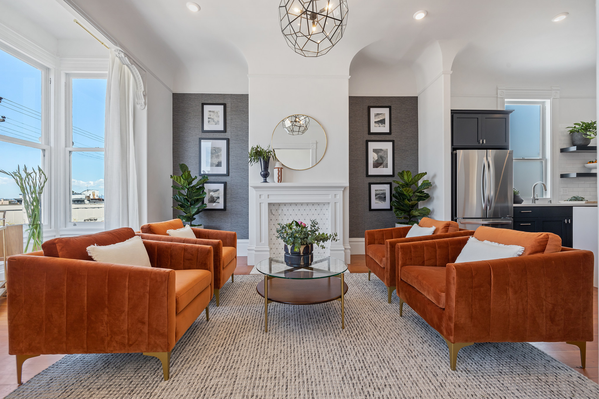 Sophisticated living room with orange chairs